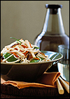 Japanese entree with sake bottle and chopsticks